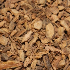 May include: Close-up of dried, brown, and tan pieces of ginger root.