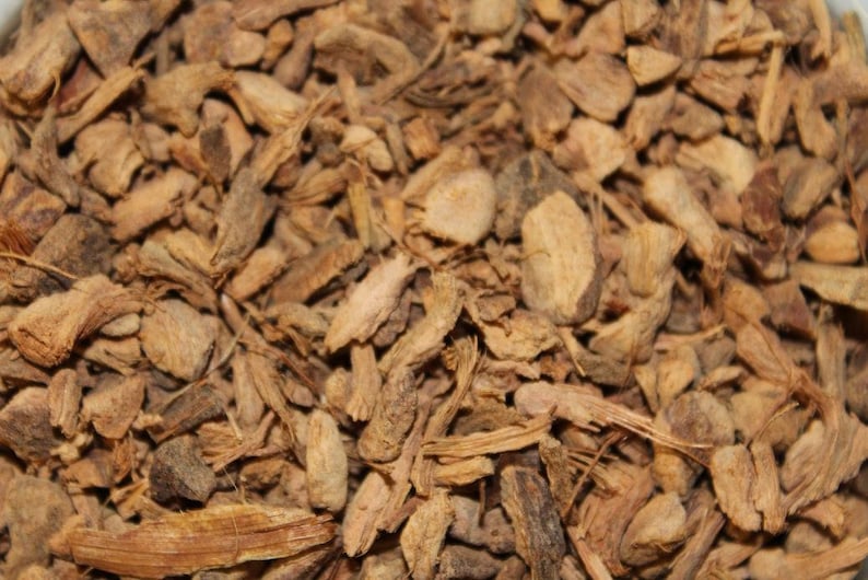 May include: Close-up of dried, brown, and tan pieces of ginger root.