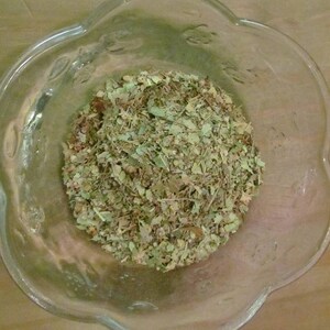 May include: A glass bowl filled with dried herbs and leaves, likely for tea or herbal remedies.