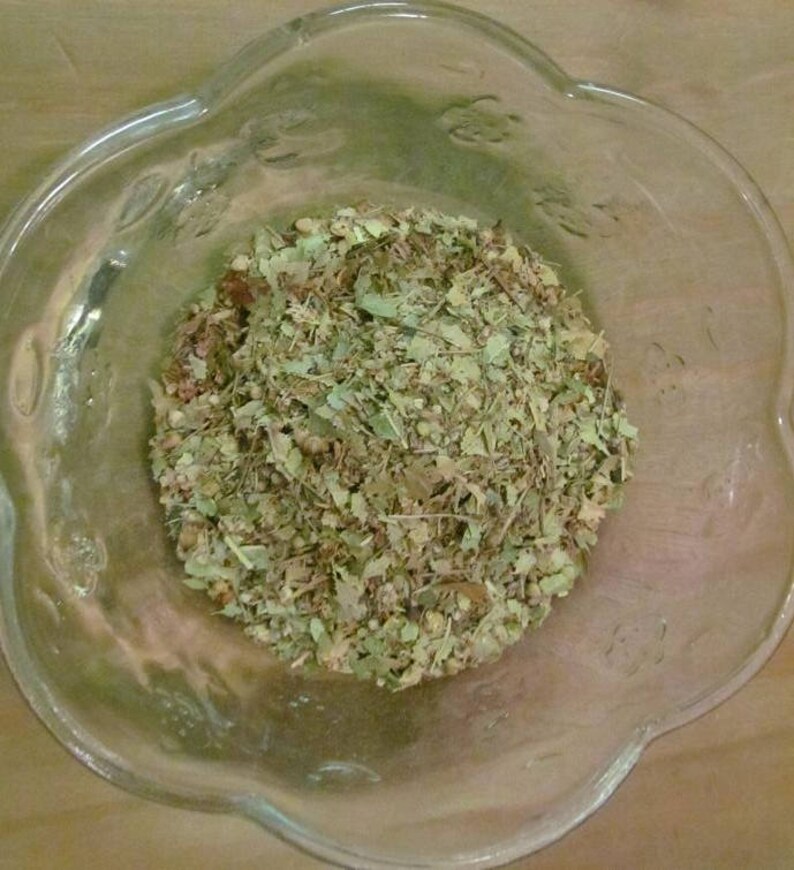 May include: A glass bowl filled with dried herbs and leaves, likely for tea or herbal remedies.