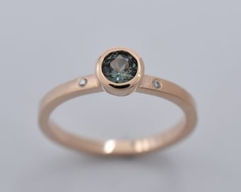14K Rose Gold Solitaire with a 4mm Teal Montana Sapphire and Flush Set Canadian Diamonds