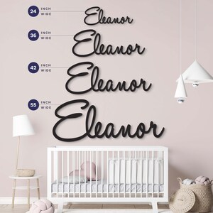 May include: Four black script wall signs displaying the name Eleanor in varying sizes. The signs are labeled with widths of 24 inch wide, 36 inch wide, 42 inch wide, and 55 inch wide, showing the scale of the lettering for wall decor applications.