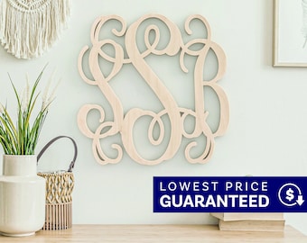 May include: A light-colored wooden wall hanging featuring an intricate, interconnected monogram of the letters S, S, and B in a cursive script font. The letters are joined together in a continuous, flowing design with decorative, swirling flourishes.