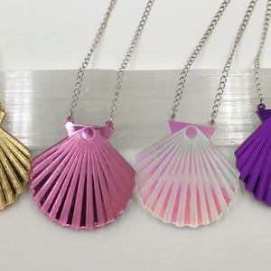 May include: Four necklaces with different colored shell pendants. The shells are gold, pink, iridescent, and purple.
