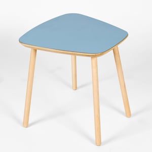 May include: A light blue side table with a rounded, slightly irregular top and four wooden legs.
