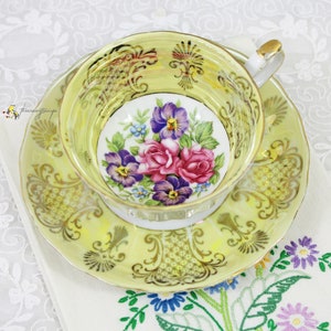 Japanese Lusterware Iridescent Yellow Gold Filigree and Pink, Purple Floral Porcelain Teacup and Saucer, 3 Legged Footed