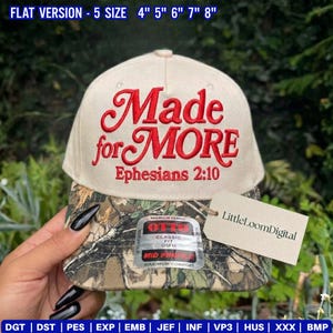 May include: A beige baseball cap with the embroidered text "Made for MORE" and "Ephesians 2:10" in red. The brim features a camouflage pattern. A tag reads "LittleLoomDigital". The hat is a classic fit, OSFM, and mid-profile.