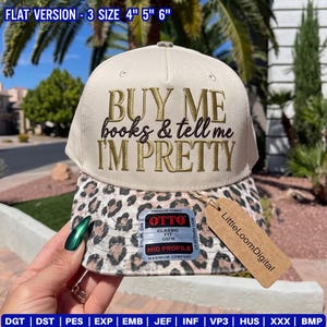 May include: A cream-colored baseball cap with a leopard print brim. The front features embroidered text that reads: BUY ME books & tell me I'M PRETTY. A brown tag labeled LittleLoomDigital is attached, and a sticker indicates a 4, 5, and 6 inch size.