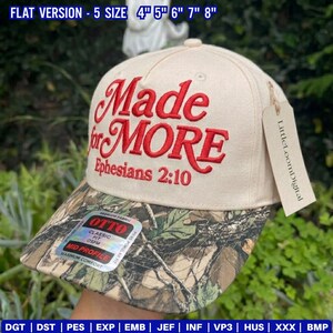 May include: A beige baseball cap with a camouflage brim. The cap has the embroidered text "Made for MORE Ephesians 2:10" in red. A tag with the text "LittleLoomDigital" hangs from the cap.