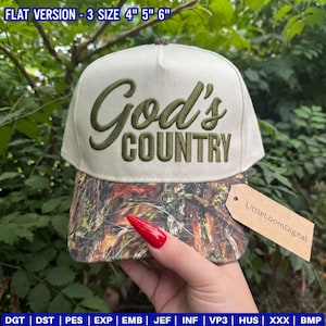 May include: A beige baseball cap with the words "God's COUNTRY" embroidered in olive green. The brim features a camouflage pattern. The tag reads "LittleLoomDigital". The hat is available in 4", 5", and 6" sizes.