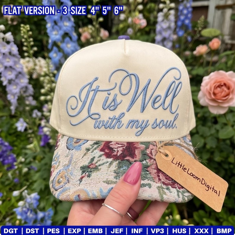 May include: Cream-colored baseball cap with the embroidered phrase "It is Well with my soul" in light blue script. The brim features a floral tapestry design. A small tag reads "Little Loom Digital".