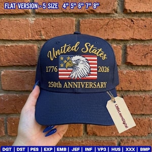 May include: Navy blue baseball cap with "United States" embroidered in gold script. Features an American flag design with an eagle and the text "1776 2026 250th ANNIVERSARY". Includes a tag that says "LittleLoomDigital".