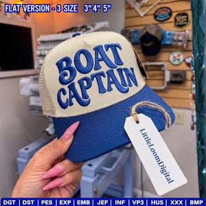 May include: A blue and beige trucker cap embroidered with the words "BOAT CAPTAIN" in blue. The cap features a mesh back and a curved peak. A tag with "LittleLoomDigital" is attached. The text "FLAT VERSION - 3 SIZE 3" 4" 5"" is at the top.