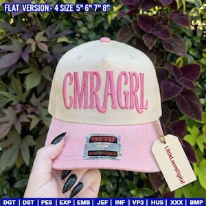 May include: A two-tone baseball cap with a pink bill and a cream-colored crown. The cap features the embroidered text "CMRAGRL" in pink. A tag with the text "LittleLoomDigital" hangs from the bill. The hat is available in sizes 5", 6", 7", and 8".