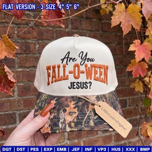May include: A cream-colored trucker hat featuring the embroidered text "Are You FALL-O-WEEN JESUS?" in black and orange. The brim displays a camouflage pattern with brown and green leaves. A tan tag labeled "LittleLoomDigital" is attached.
