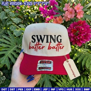 May include: A baseball-style cap with a cream-colored crown and a red brim. The cap features the embroidered text "SWING batter batter" in black and red. A tag with the text "LittleLoomDigital" hangs from the brim.