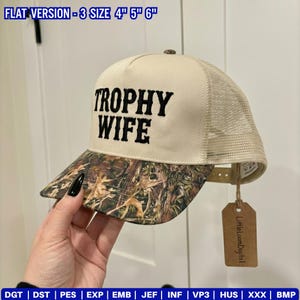 May include: A beige and camouflage trucker hat with the words "TROPHY WIFE" embroidered in black. The hat has a mesh back and a curved brim. The hat is available in sizes 4", 5", and 6".