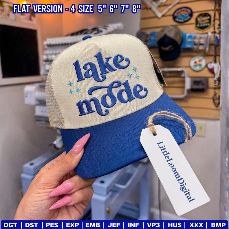 May include: A blue and beige trucker hat with the words "lake mode" embroidered on the front. The hat has a mesh back and a curved brim. The tag reads "LittleLoomDigital".