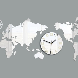 May include: A white mirrored world map wall clock with Roman numeral markings. The clock is centered on a gray background with a compass design in the top left corner.