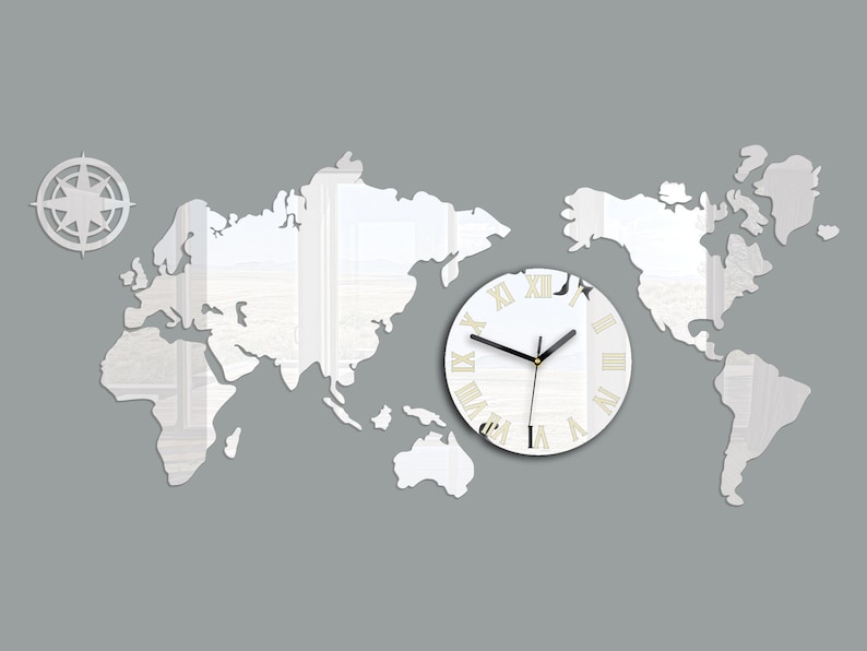 May include: A white mirrored world map wall clock with Roman numeral markings. The clock is centered on a gray background with a compass design in the top left corner.