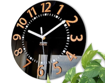 May include: A black clock with gold numbers and a white face. The clock has a modern design and is perfect for any home.
