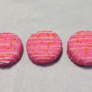 12 Pink Chocolate Covered Oreo Cookies with White Chocolate Drizzle and Gold Sprinkles
