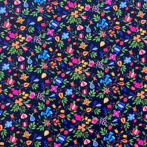 May include: A fabric with a dark blue background covered in a vibrant floral pattern. The design features a variety of colorful flowers in shades of pink, orange, yellow, and blue, with green leaves and stems. The overall effect is a dense, cheerful pattern.