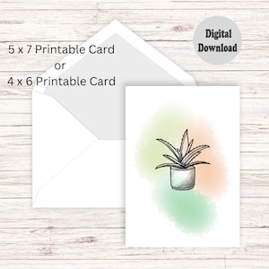 Może przedstawiać: Drukowana karta z rysunkiem aloesu w doniczce na tle akwarelowym w odcieniach zieleni, pomarańczy i żółci. Karta dostępna jest w dwóch rozmiarach: 5x7 cali lub 4x6 cali.