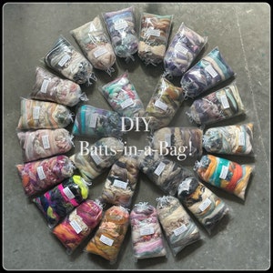 May include: A collection of 20 colorful DIY Batts-in-a-Bag, each containing a variety of fibers in a clear plastic bag. The bags are arranged in a circle on a gray surface.