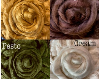 May include: Four different colors of cotton fiber, arranged in a grid. The colors are turmeric, espresso, pesto, and cream.