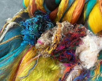 May include: A close-up of colorful hand-spun yarn. The yarn features a variety of colors, including yellow, blue, orange, and red. The texture is a mix of smooth and textured fibers, ideal for fiber art projects.