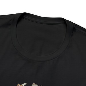 May include: Black t-shirt featuring a bee and flower graphic.