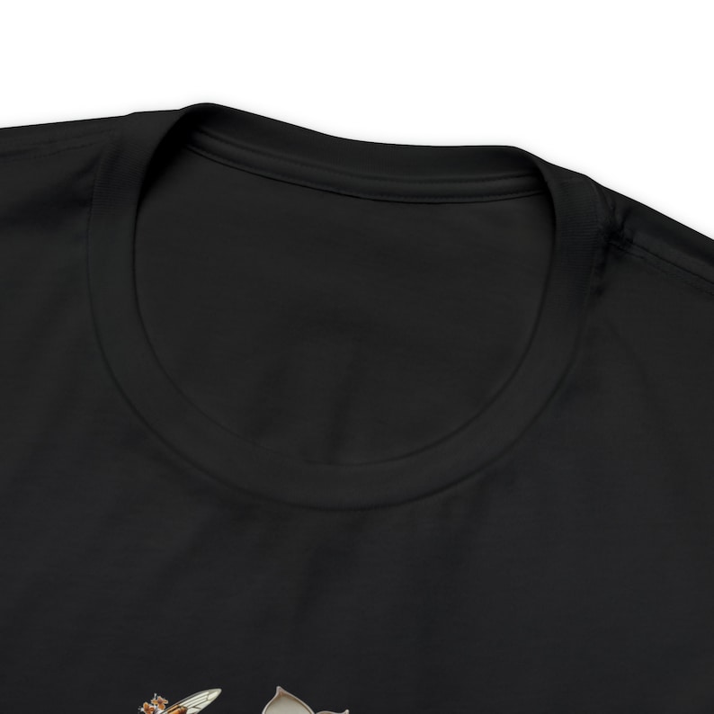 May include: Black t-shirt featuring a bee and flower graphic.
