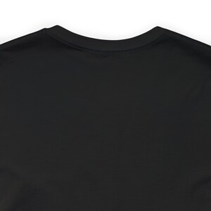 May include: Black long-sleeved t-shirt with a crew neck.