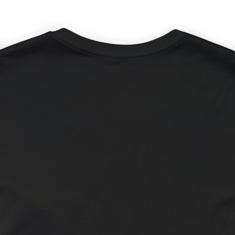 May include: Black long-sleeved t-shirt with a crew neck.