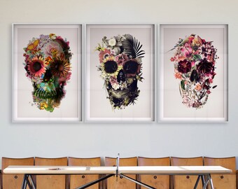 May include: Three framed prints of floral skull designs. Each print features a skull with different colored flowers and foliage.