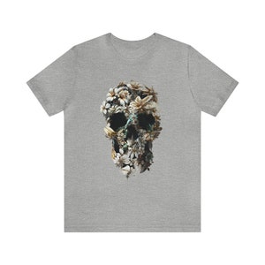 May include: A grey t-shirt featuring a floral skull design. The skull is made up of white and yellow flowers.