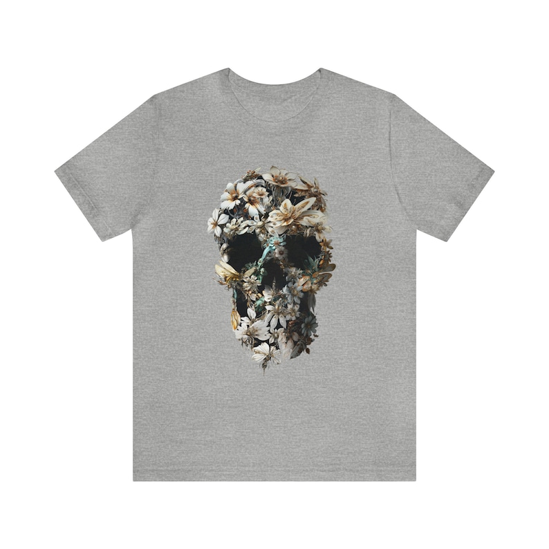May include: A grey t-shirt featuring a floral skull design. The skull is made up of white and yellow flowers.