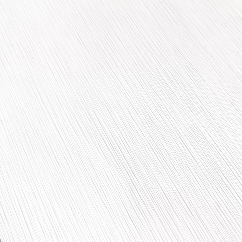 May include: A close-up shot of a white surface with a textured, linear pattern. The lines run diagonally across the frame, creating a sense of depth and visual interest. The texture appears to be slightly raised, adding to the tactile quality.