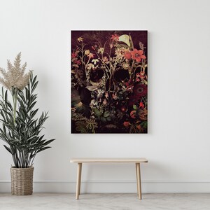 May include: A dark background with a skull made of flowers. The skull is made of various flowers in shades of red, pink, and white. The flowers are arranged in a way that creates the shape of a skull. The background is a dark, almost black, color.