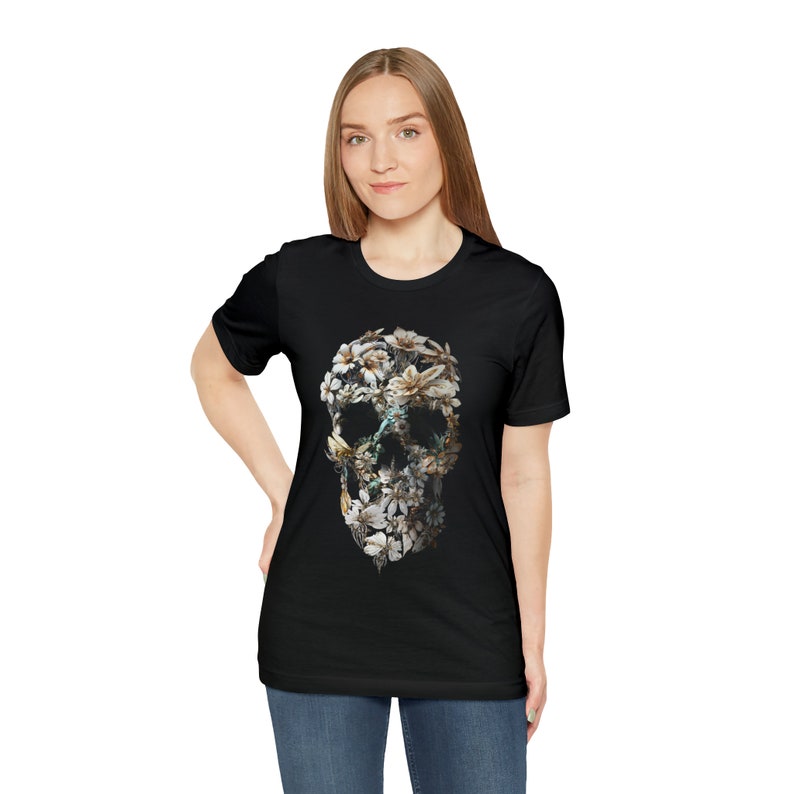 May include: A black t-shirt featuring a floral skull design. The skull is made up of white and brown flowers.