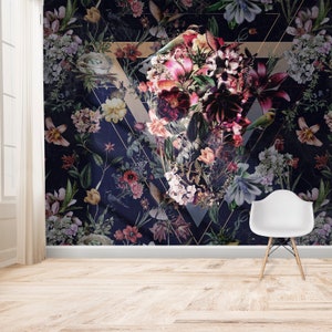 May include: Dark navy floral wallpaper with a large geometric design. The wallpaper features a variety of flowers in shades of pink, red, and purple, with green leaves and small birds. A white chair sits in front of the wallpaper.
