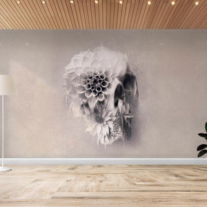 May include: A grayscale wall mural featuring a skull design with floral elements. The artwork is displayed in a room with a wooden floor, a white floor lamp, and a potted plant. The room has a neutral color palette.