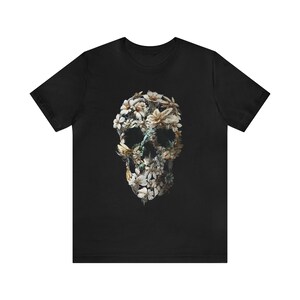 May include: Black t-shirt featuring a floral skull design. The skull is composed of white flowers and green leaves.