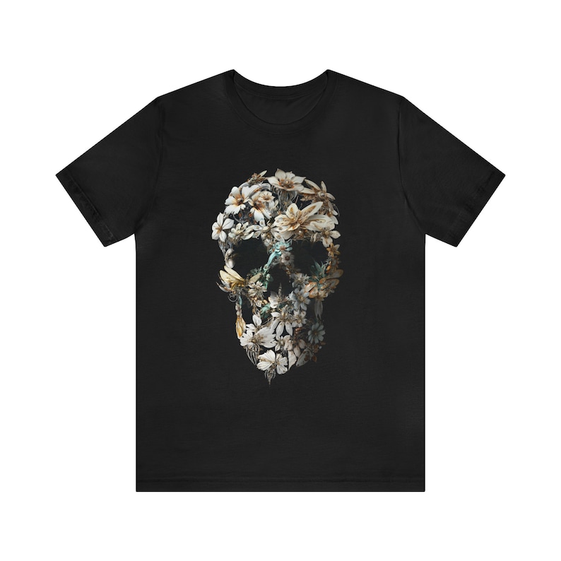 May include: Black t-shirt featuring a floral skull design. The skull is composed of white flowers and green leaves.