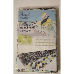 May include: A fabric bundle from Annie's Creative Quilters Fabric Club. The package features the "Homestead Collection" by Clothworks. The fabric has a mix of rustic and modern designs with old-time spinning wheels and water pumps. The fabric is 100 percent cotton.