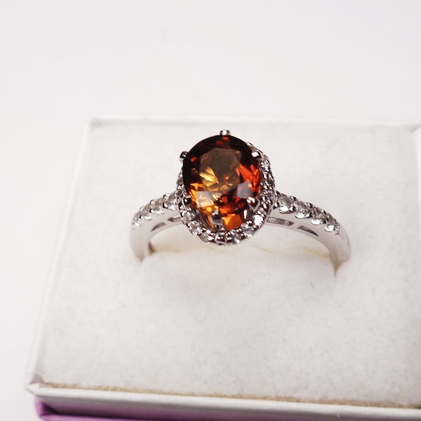 Beautiful Copper Tourmaline in a Sterling Silver Ring with topaz accents. 1.5 Carat, 8 x 6mm. Tourmaline Oval.