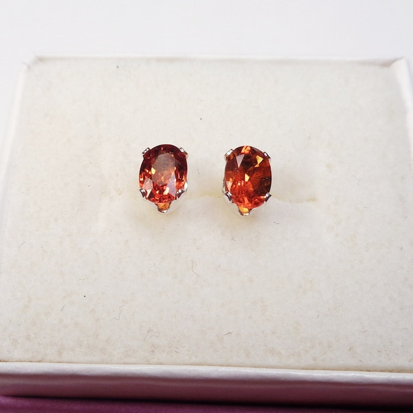 7 x 5mm. Oval, Orange, Red, Spessartite Garnet, Post Earrings in Sterling Silver. 0.9 Carats Total Gem Weight.