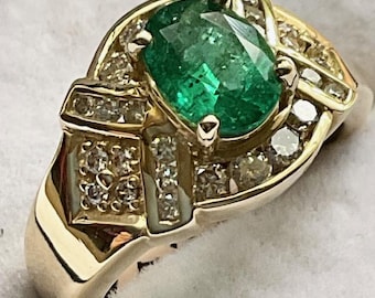 Emerald Ring set in 14kt Gold.  1.10ct. natural Emerald with .56ctw. in Diamonds