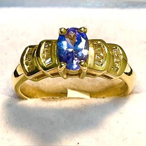 14kt. Gold, Tanzanite Ring. 7 x 5mm. Oval in a 14kt. Yellow Gold Ring with Diamonds.